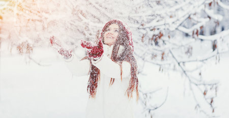 happy young woman in winter hat. snow fallの写真素材