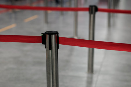 Red tape portable barrier in airport. Travel and airport securityの写真素材
