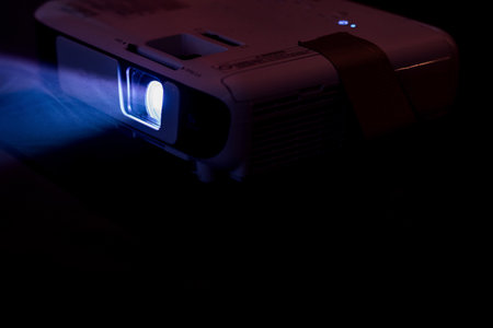 Blue color wide lens projector with light beam for movie video and cinema at night . abstract smoke texture spotlight screening for multimedia productionの写真素材