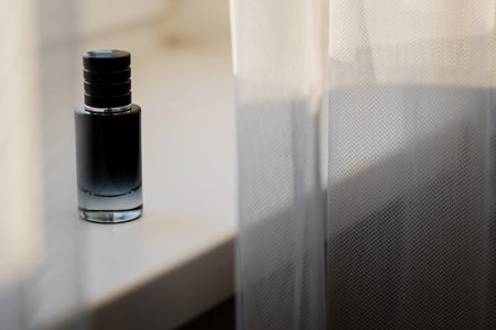 bottle of men's perfume on the window. mens perfume spray bottle