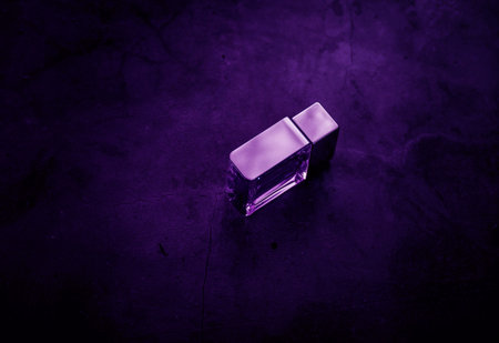 fragrance perfume bottle on dark empty background. top view. Horizontal
