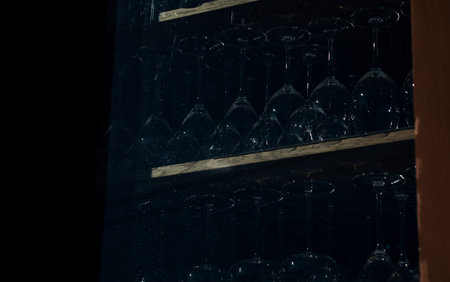 clean wine glasses stacked in front of window backgroundの写真素材