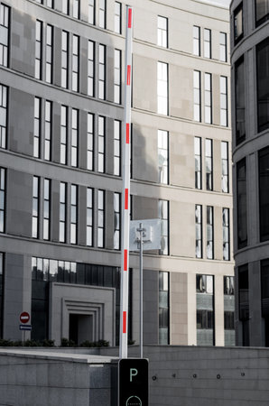 red and white barrier. entrance on parking. Raised or closing arm barrierのeditorial素材