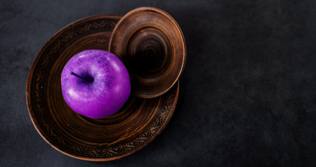 Fresh juicy ripe apple in plate on dark background. copy spaceの写真素材
