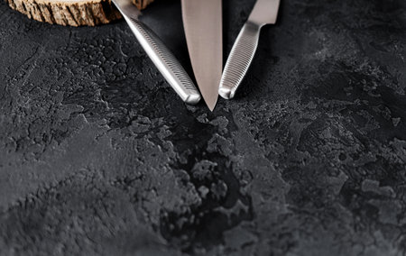 sharp stainless steel knives on a dark background. copy spaceの写真素材