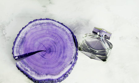 Perfume on wooden tray background. Luxury and natural cosmetics presentation. top view