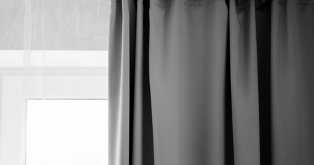 gray textiles. curtains are suspended from the ceilingの写真素材