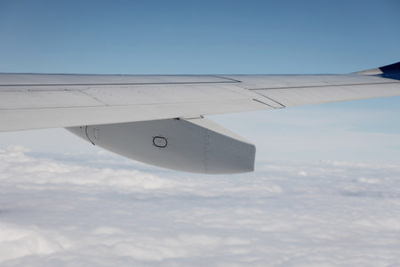 Aircraft's wing on sky. Wing aircraft in altitude during flightの写真素材
