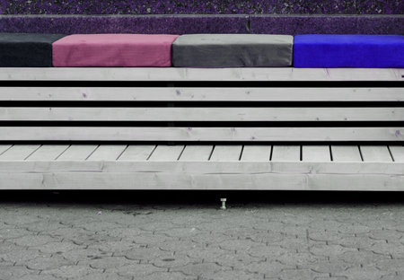 pillows on outdoor patio chair, with striped cushioned bench