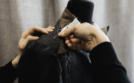 male tailor works in a costume workshop. tailoring and repair of clothingの写真素材