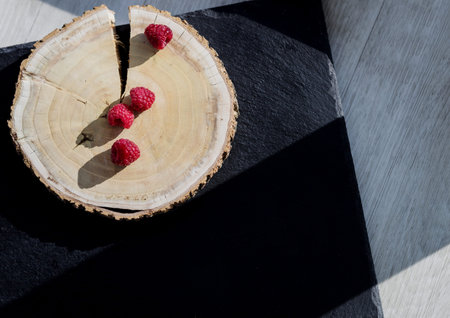 Fresh raspberry in a wooden plate. organic foodの写真素材