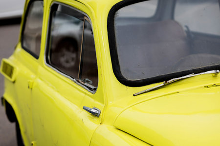 part old vintage bright yellow retro car. classic carの写真素材
