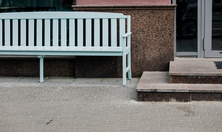 urban wooden cozy bench near the buildingの写真素材