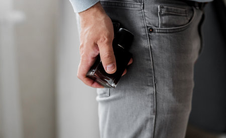 Man holding bottle of perfume and smells fragranceの写真素材