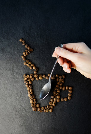 Grains of coffee in the form of cup with steam. fresh coffee beansの写真素材