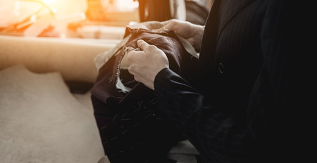 tailor is holding a cloth in his hands. fashion designerの写真素材