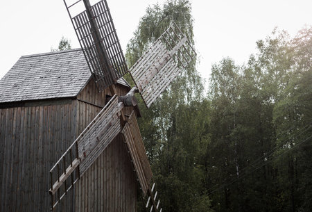Old wooden windmill on field in summer day. ecologyの写真素材