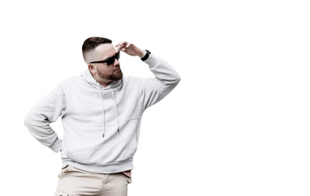 handsome hipster man with beard on white background in gray blank hoodie or sweatshirt with space for your logo or design.の写真素材