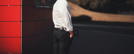 Portrait of a young handsome man, model of fashion, wearing shirt in urban backgroundの写真素材