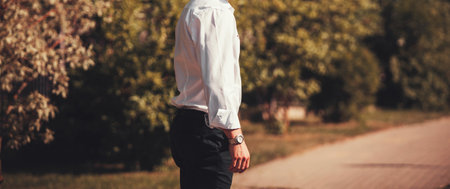 Portrait of stylish handsome young man standing outdoors. Man wearing shirt and watch.の写真素材
