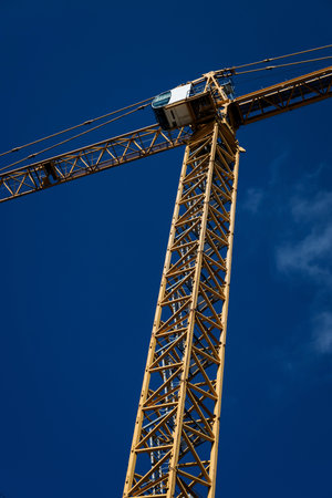 big yellow tower crane on construction siteの写真素材