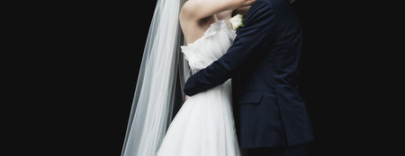 Wedding couple, portrait of bride and groom on wall background with copy space. Young and beautiful couple in loveの写真素材