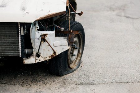 old car with a broken wheel. tire punctureの写真素材