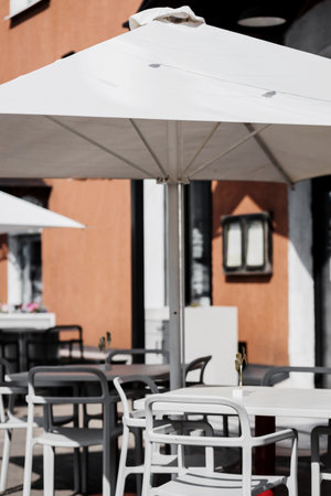 Restaurant terrace umbrella. Modern exterior of summer cafe.の写真素材