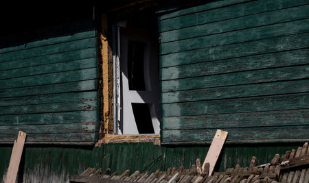 destroyed house with broken windows. old abandoned houseの写真素材