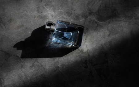 Transparent bottle of perfume with spray on marble surface. Trending concept in natural materials with shadow. luxury presentation.の写真素材
