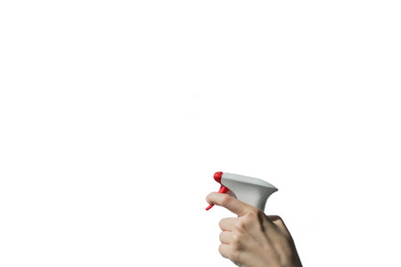 Spring cleaning concept. Hand holding spray bottle isolated on white background. cleaning serviceの写真素材