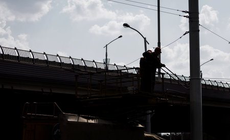 a worker paints a pole in a cradle. working at heightの写真素材
