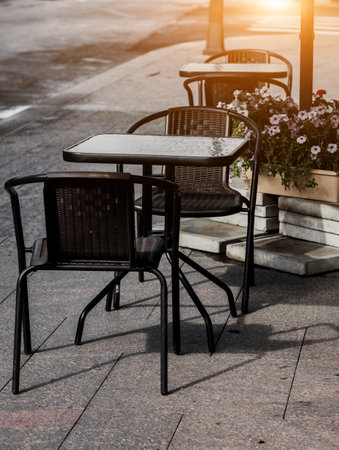 table and chairs at a sidewalk cafe. cozy street restaurantの写真素材