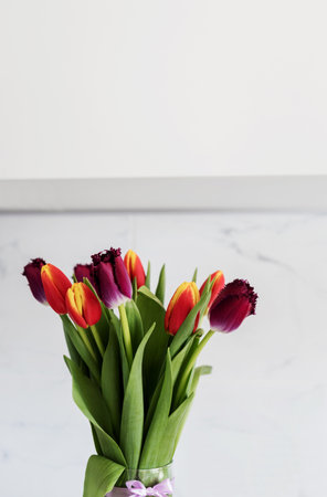 Multicolored tulips in a vase. bouquet of beautiful tulipsの写真素材
