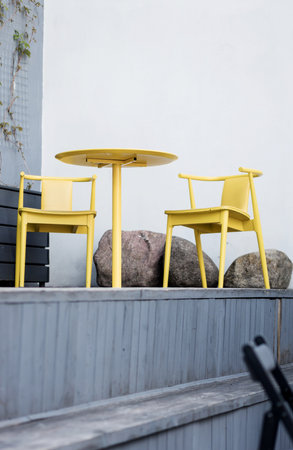summer cafe with yellow tables and chairs. stylish furniture. street bistroの写真素材
