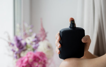 sensual woman using perfume. lady holding a perfume bottle.の写真素材