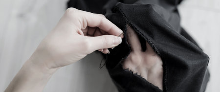 hole in the clothing. restoration of old textiles and fabricsの写真素材