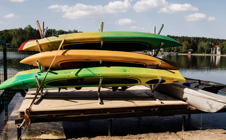 colorful kayaks lie in a row on the shore. travel conceptの写真素材