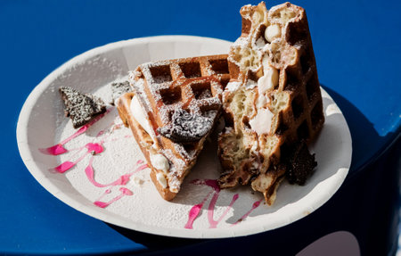 Waffles with sugar on blue table. sweet breakfastの写真素材