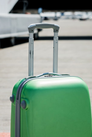 suitcase with handle on wheels in airport. travel conceptの写真素材