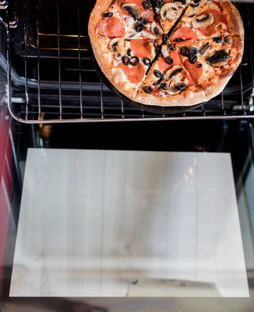 homemade pizza with olives prepared for baking in the ovenの写真素材