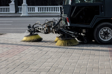 Sweeping machine brushes clean the city sidewalk. city background with sweeper.の写真素材