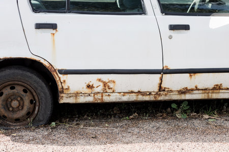 Corrosion, rust on the car body. car with rust. The concept of harm from reagents for the environmentの写真素材