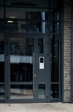 Intercom and security camera on wall outside residential building.