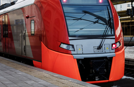 Beautiful railway station with modern red commuter train