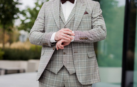 Businessman adjusting his watch. elegant successful man in suitの写真素材