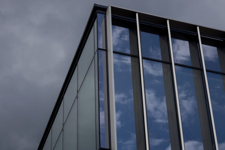 Modern office building or business center. window buildings made of glass reflect the cloudsの写真素材