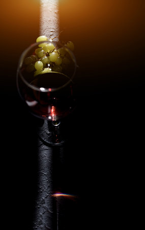 Glass of wine on dark wooden tableの写真素材