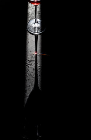 red wine on dark background. Wine glass on wooden tableの写真素材