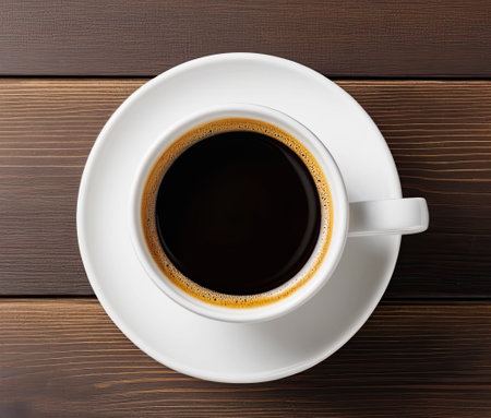 One coffee cup top view on wooden background. Cafe and bar conceptの素材